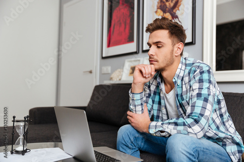 Concentrated bristle man using laptop computer. © Drobot Dean