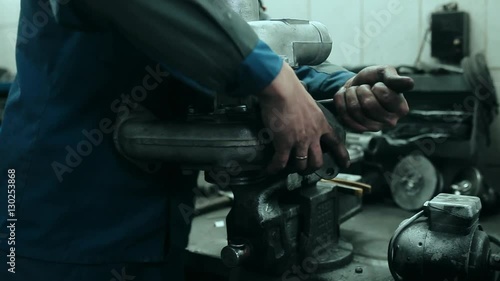 Auto mechanic repairs a turbocharger
