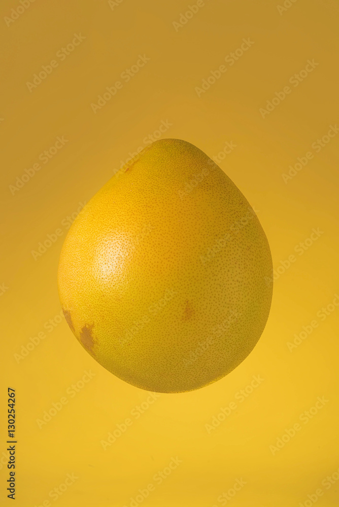 Pomelo isolated on yellow background Pomelo isolated on yellow background