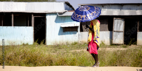 Woman in South Sudan with umbrella from sun photo