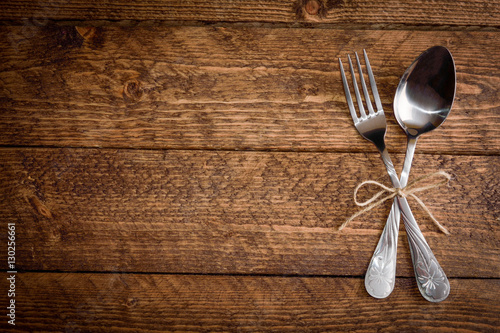 cutlery fork and spoon on a wooden background