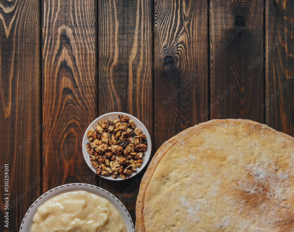 Ingredients for baking a cake, top view on wooden board. shortcakes, buttercream Ingredients for baking a cake, top view on wooden board. shortcakes, buttercream