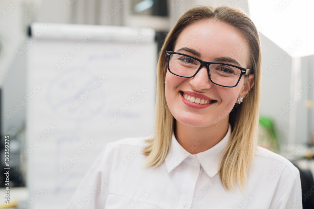 Pretty blonde designer smiling at camera in creative office Pretty blonde designer smiling at camera in creative office