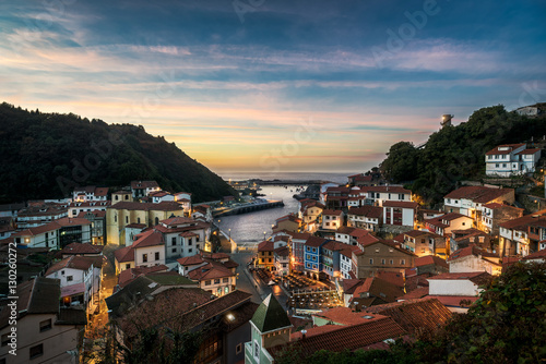 Beautiful view of coastal Asturias sea village Cudillero.in Spain, Europe during sunset or dusk. Gorgeous panorama of nature traditional famous touristic summer destination at dusk or dawn. photo