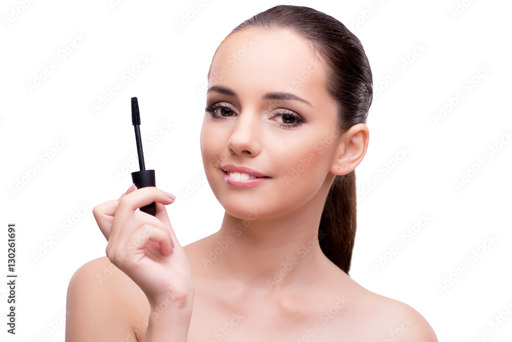 Woman brushing eyelashes isolated on white Woman brushing eyelashes isolated on white