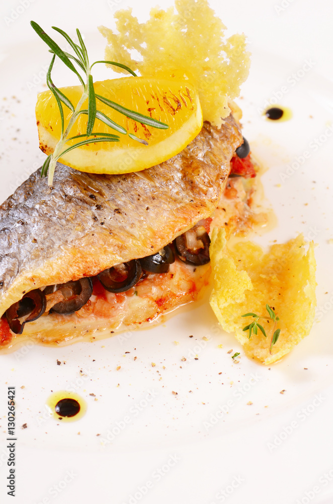 Baked fish stuffed with olives Stock Photo | Adobe Stock