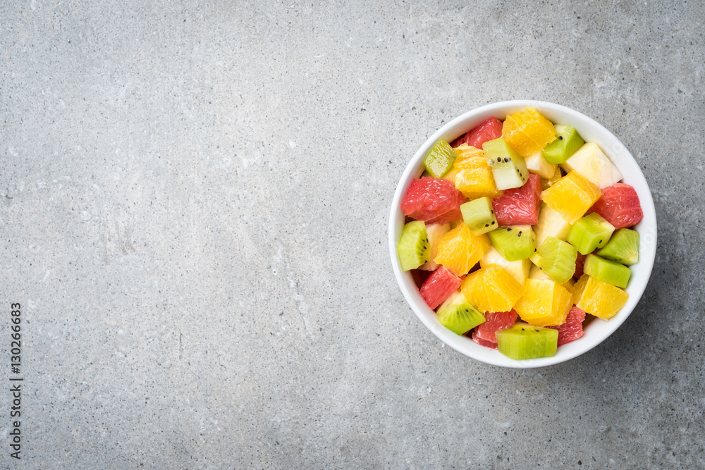 Fresh fruit salad on gray stone table Fresh fruit salad on gray stone table