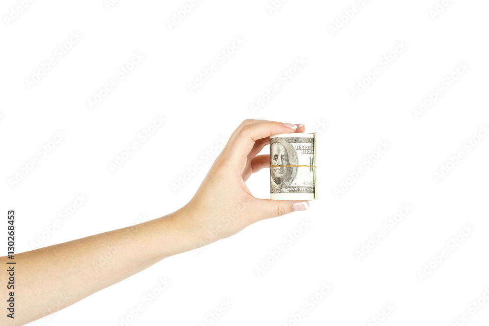 Female hand with twisted stack of dollars on white background. Female hand with twisted stack of dollars on white background.