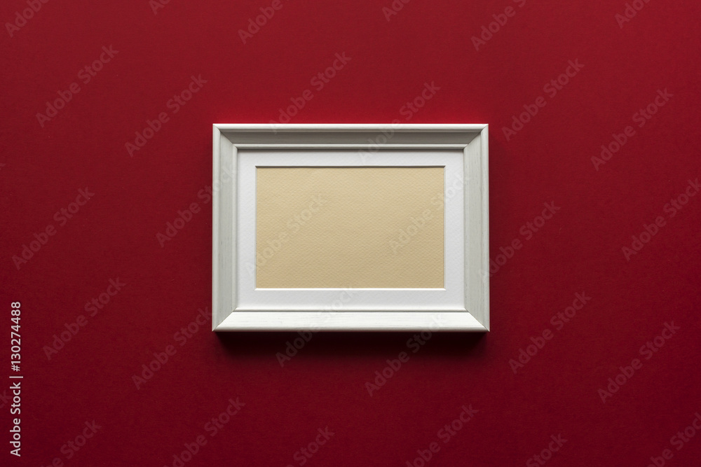 little white wooden frame on red vinous background little white wooden frame on red vinous background