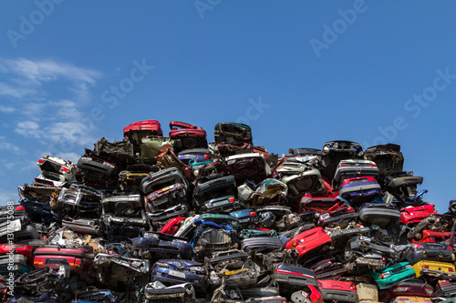 Stacked cars on a junkyard photo