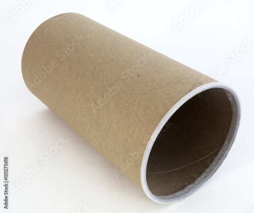 Empty cardboard packaging canister on its side.