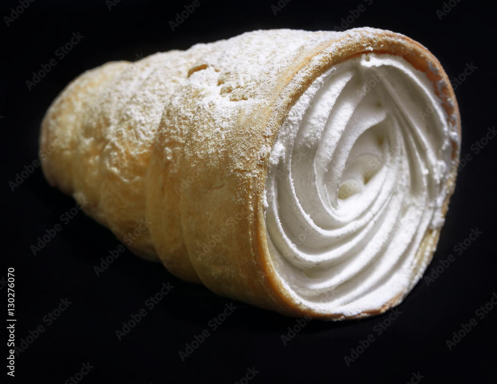 Lemon meringue cake with cream on a black background. Lemon meringue cake with cream on a black background.