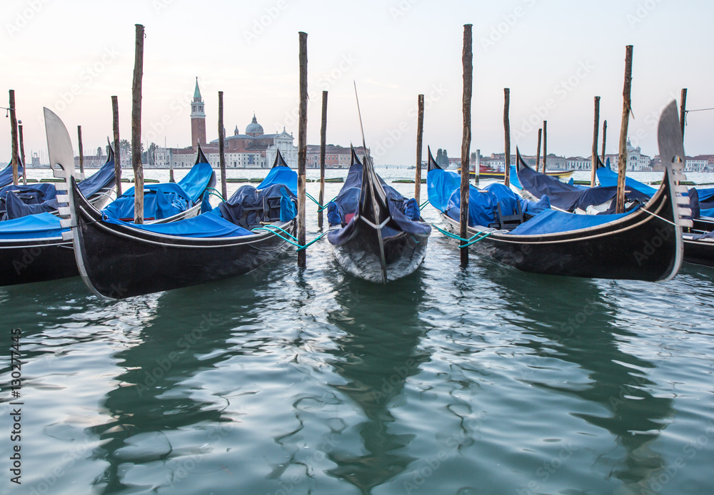 Long exposure of gondolas docked near St Marc square in Venice, Italy.