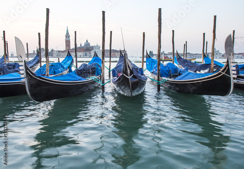 Long exposure of gondolas docked near St Marc square in Venice, Italy.