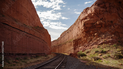 railroad tracks between high rock walls 