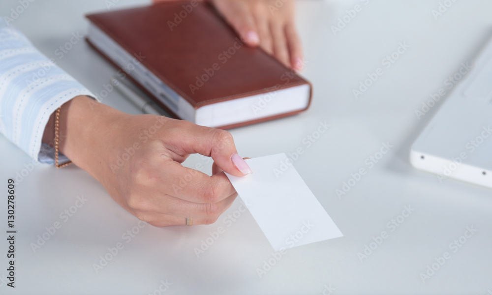 Smiling business woman handing a blank card over white background Smiling business woman handing a blank card over white background