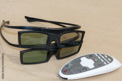 Remote control and 3D glasses on craftool background photo