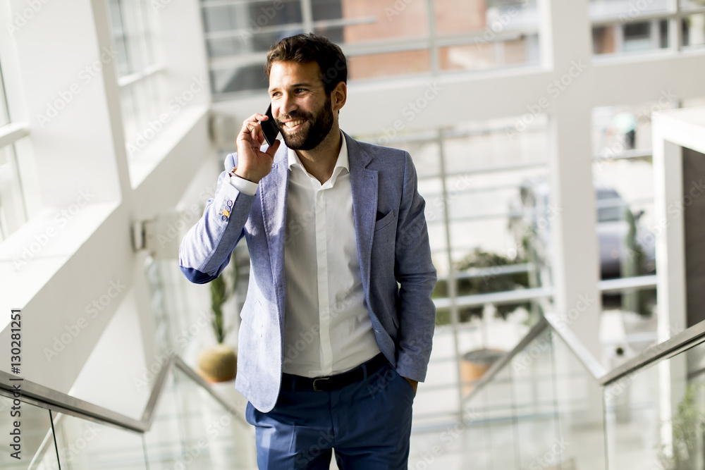Handsome businessman in suit using the phone Handsome businessman in suit using the phone