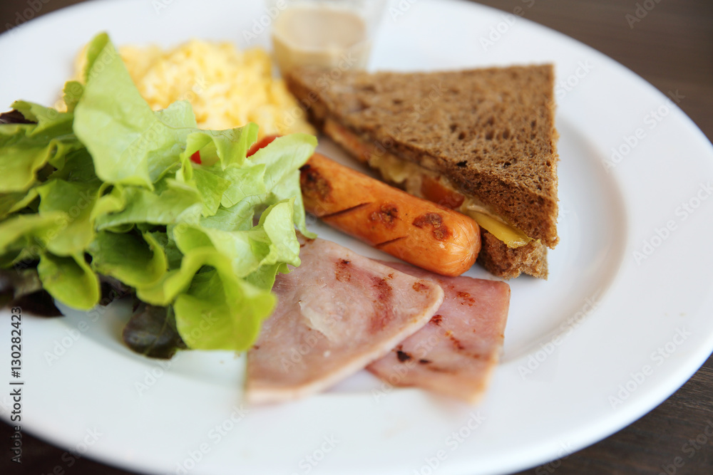 Breakfast with ham , fried egg and bread