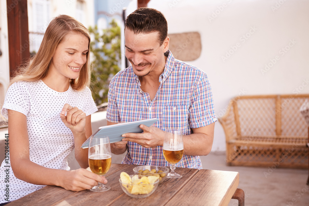 Interested young couple looking at tablet