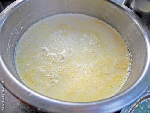 Boiling soy milk with thin yuba or tofu film in a steel pot