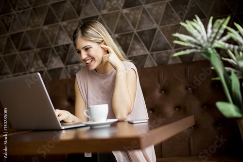 Young woman in cafe with laptop