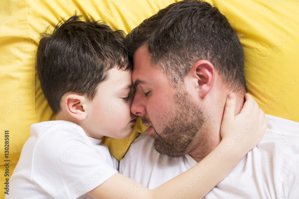 Father and son in bed, happy time Father and son in bed, happy time