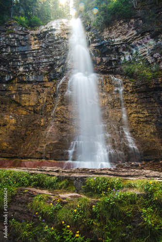 Waterfall flowing into a lush valley.  Portrait 