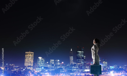 Woman looking at night city