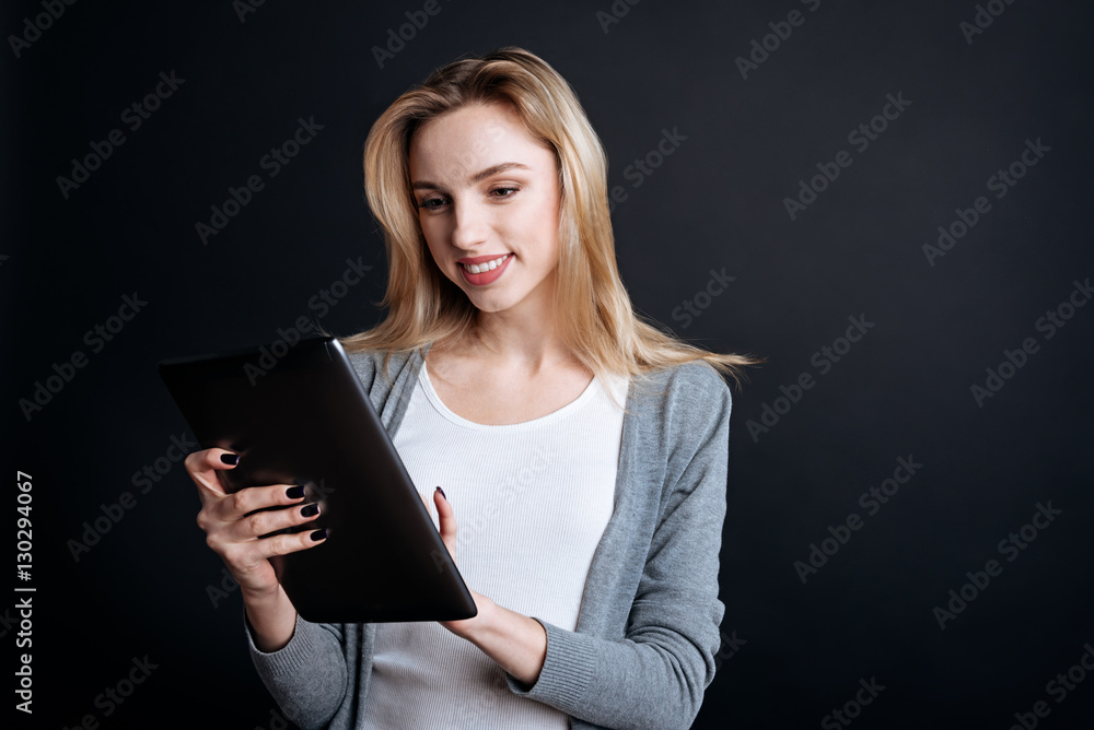 Cheerful young woman using tablet Cheerful young woman using tablet