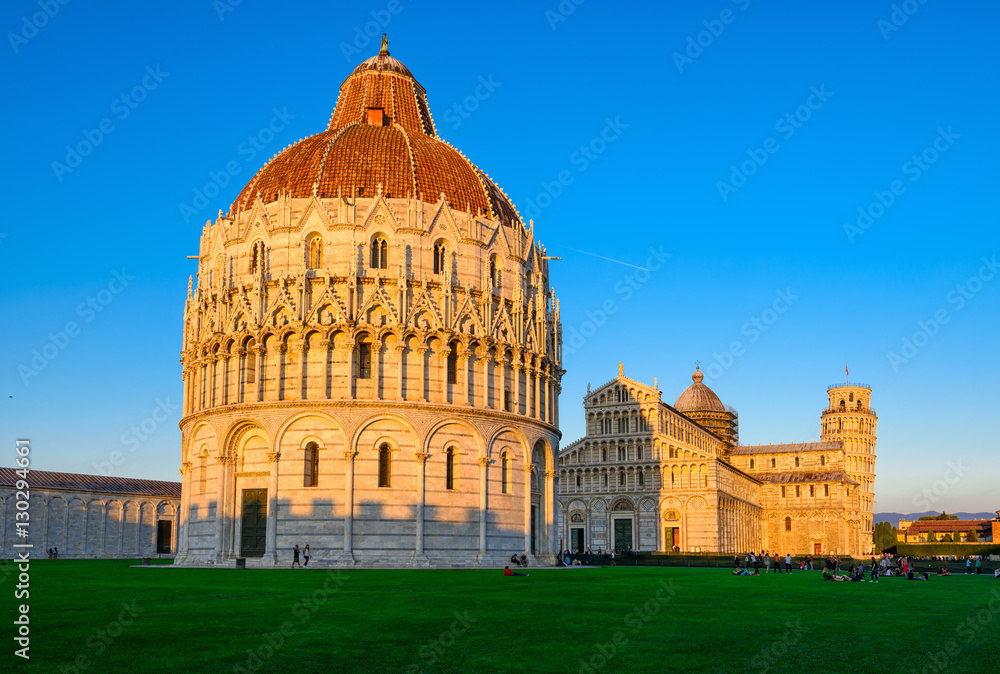 Sunset view of Baptistery of St. John (Battistero di San Giovanni di Pisa), Pisa Cathedral (Duomo di Pisa) with the Leaning Tower of Pisa (Torre di Pisa) on Piazza dei Miracoli in Pisa, Tuscany, Italy