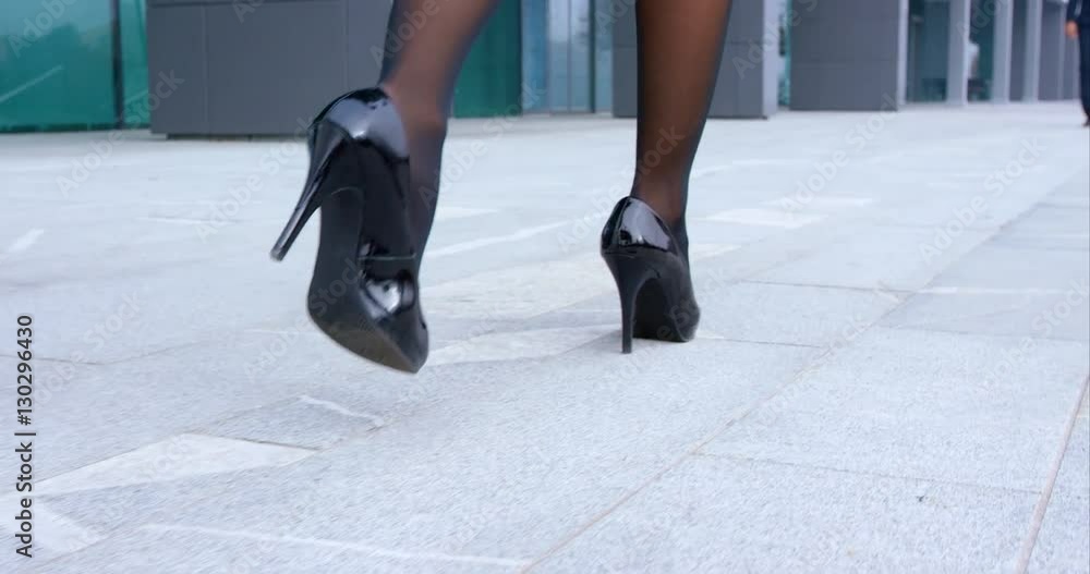 Business Woman Walking In High Heels To Meet Her Co-Worker Business Woman Walking In High Heels To Meet Her Co-Worker