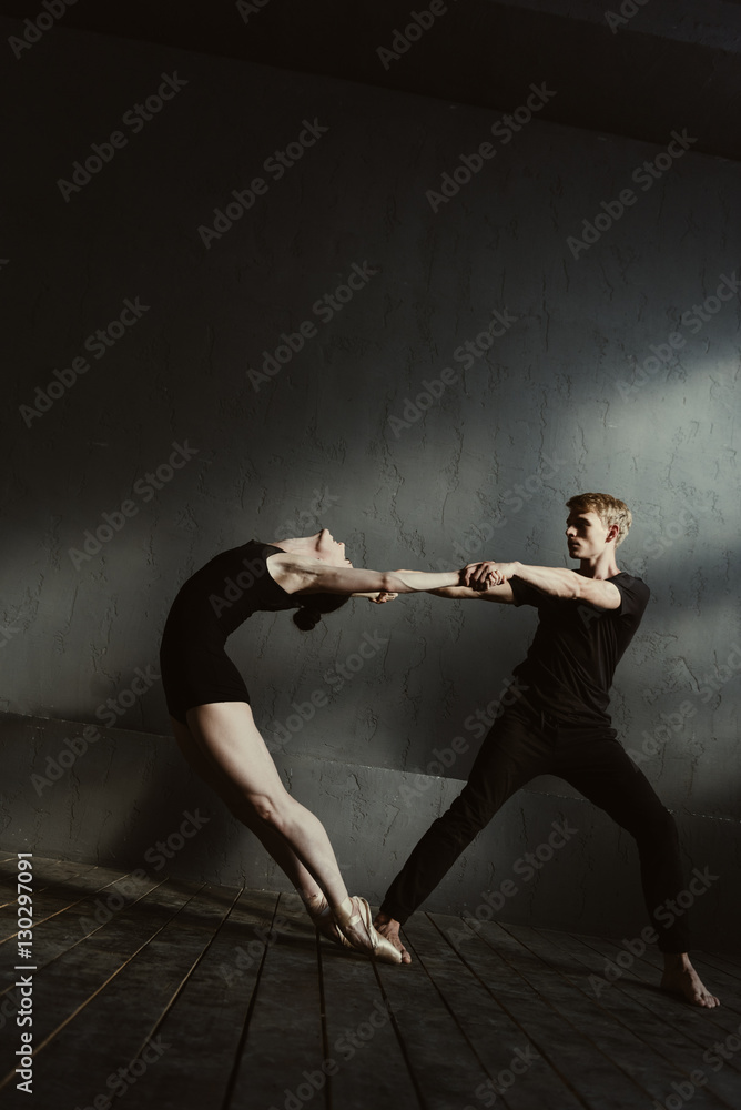 Flexible gymnasts stretching in interaction with each other Flexible gymnasts stretching in interaction with each other