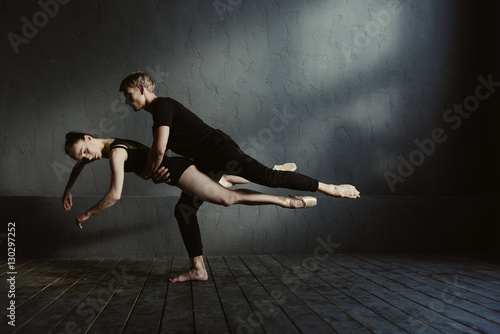 Skilled proficient ballet dancers demonstrating their flexibility
