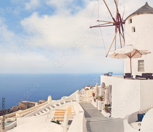 white greek windmill and cafe on sunny day