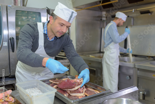 Chef seasoning cuts of meat