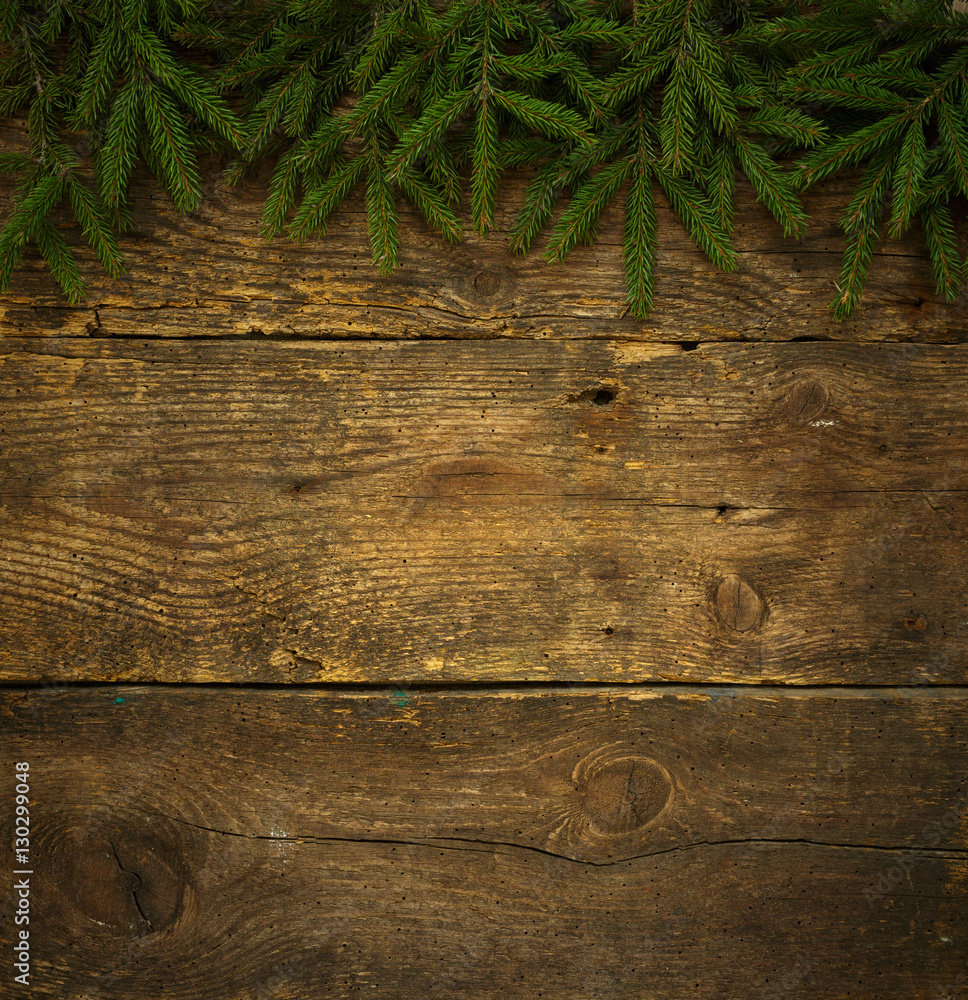 Christmas tree branches on wooden texture ready for your design Christmas tree branches on wooden texture ready for your design