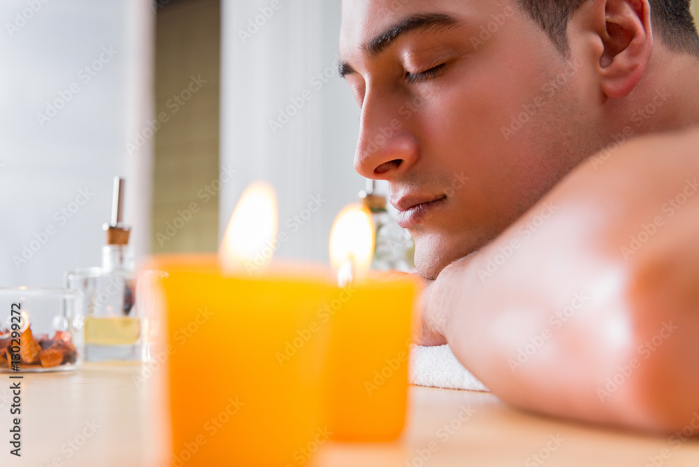Handsome man during spa massaging session Handsome man during spa massaging session