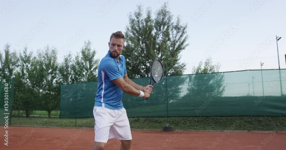 Tennis Player Hits The Ball With Backhand Stroke Tennis Player Hits The Ball With Backhand Stroke