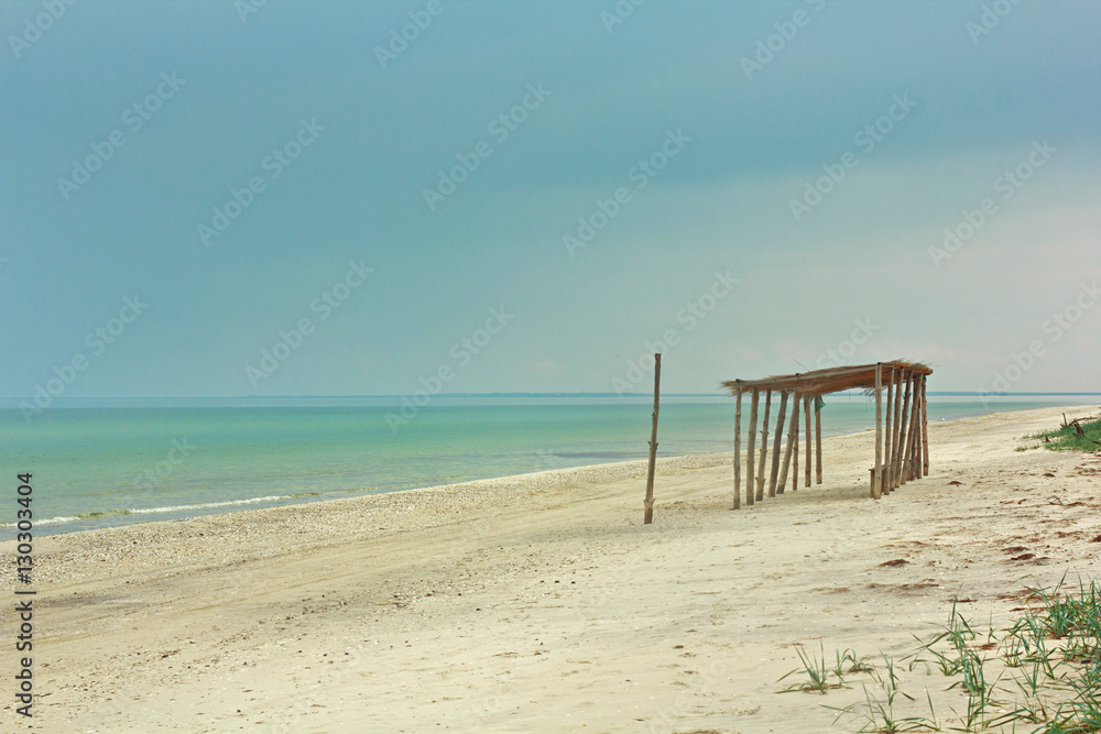 Wooden bungalow on the azure tropical seaside sunny day Wooden bungalow on the azure tropical seaside sunny day