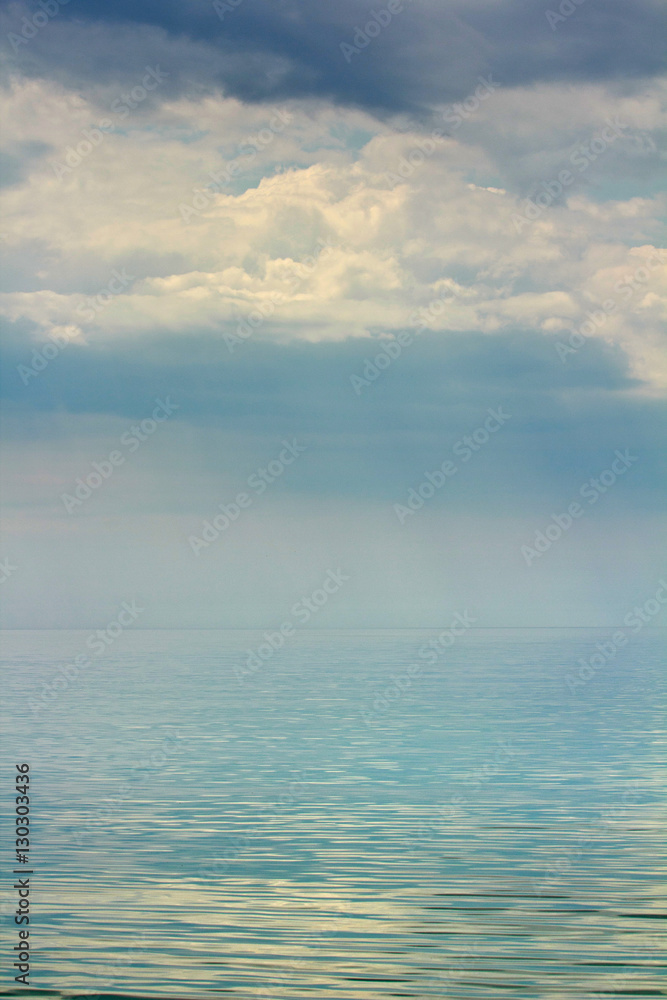 Fototapeta premium Gloomy skies over mirrored surface of the sea