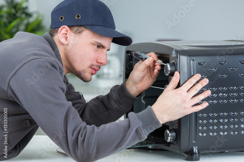 Repairman working on domestic appliance