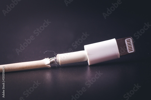 Obraz na plátně Closeup the Broken Smart Phone Charger Cable on black Background