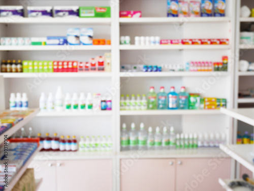 pharmacy store with blur medicines arranged on shelves