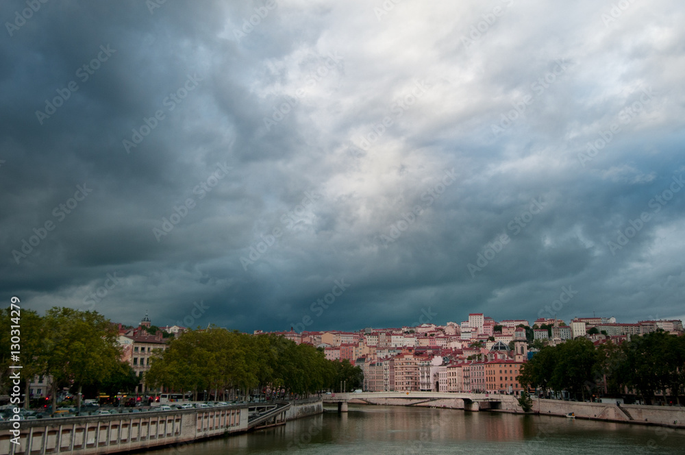 Storm Clouds loom over the cityscape of the city of Lyon and the River Soane.