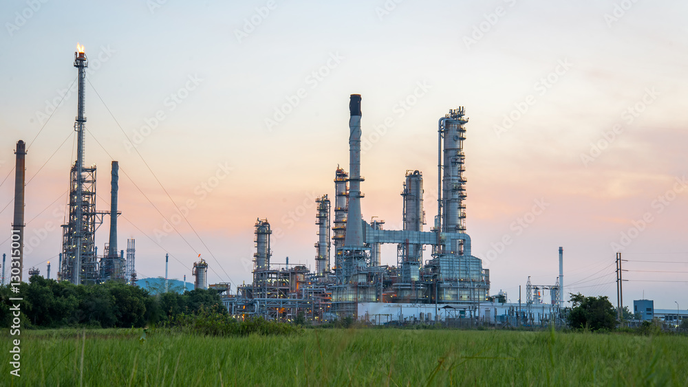 Oil refinery plant at sunrise with sky background