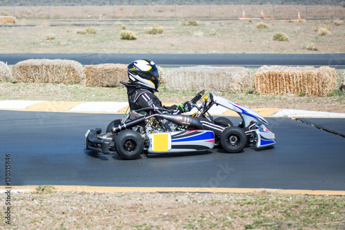Young kid racing a go cart around a track. © ecummings00