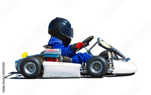 Young kid racing a go cart around a track. Panned to show speed.