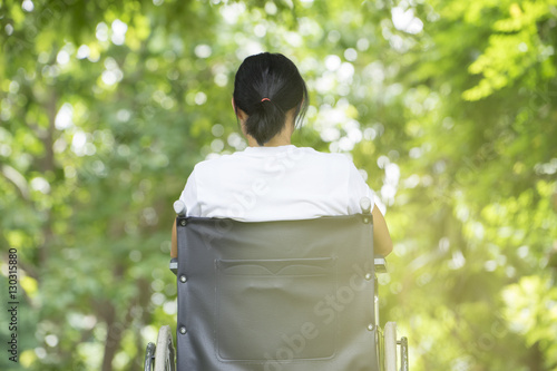 Tableau sur toile woman using a wheelchair in a park