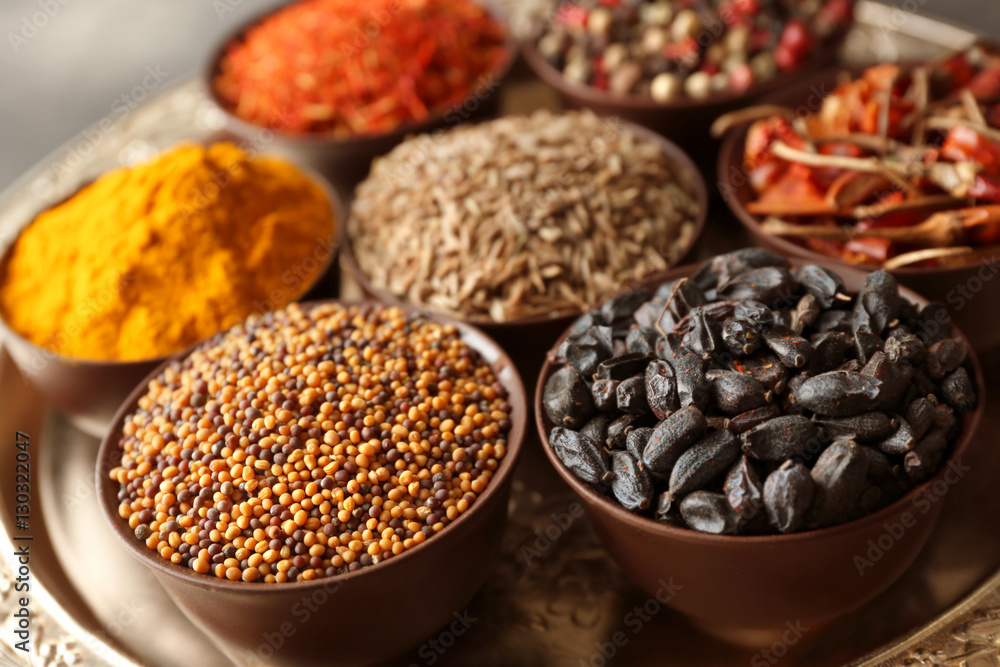 Different spices in bowls on plate Different spices in bowls on plate